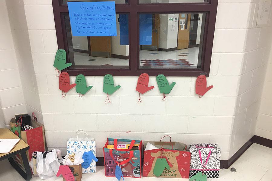 Seven remaining mittens hang from the wall. The donor was to purchase the desired gift and turn it into the front office by December 13.