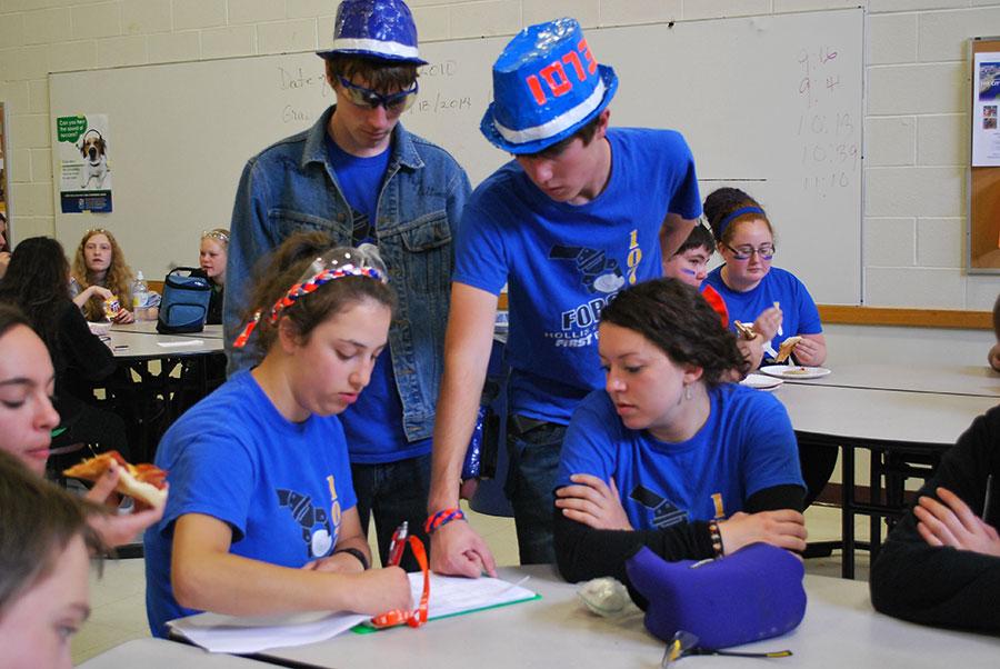 Members of the strategy subgroup working with their data from scouting as they figure out ideal teams to form alliances with