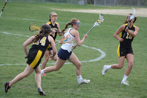 Senior Sydney MacLeod running down the field in a game against Souhegan.