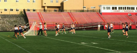 Kaitlin Johnson '17 battles a Crusaders player behind the net in attempt to gain control of the ball.
