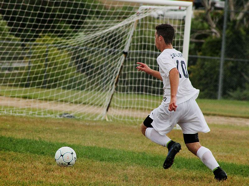 Jack Barbour 16 moves the ball down-field in a boys varsity soccer match this season.