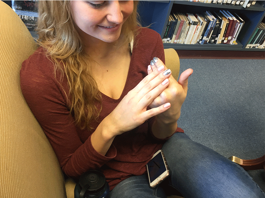 Mikey Lemay 17 admiring her beautiful painted nails.