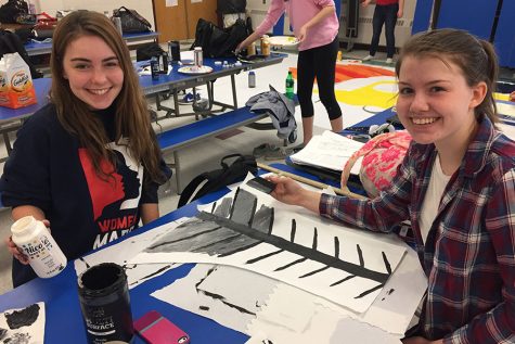 Emma Bruseo '17 and Meghan Corban '17 help with details on the seniors' poster.