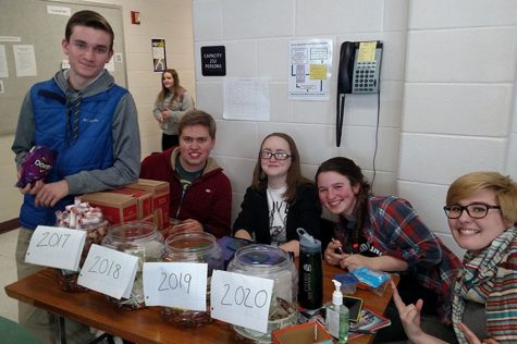 Students sitting with the class jars on the last day of Penny Wars. From left to right: Nathan Buckley '17. Chris Aulbach '17, Caitlin Ross '17, Audra Paradie '17, and Abby Lewis '17.