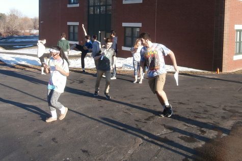 The sophomore class practices their Spirit Week skit outside.