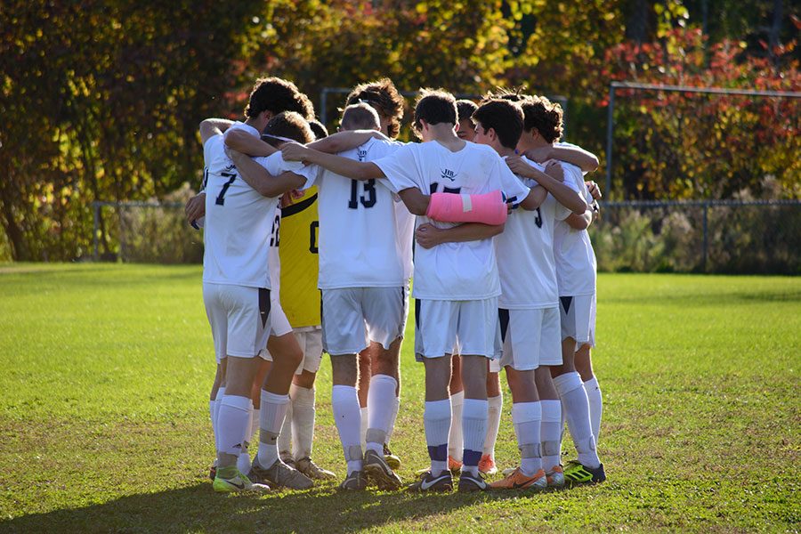 Huddling+before+the+game%2C+the+seniors+on+the+soccer+team%2C+plus+a+few+other+starters%2C+take+a+moment+to+get+in+game-mode.+The+boys+played+St.+Thomas%2C+a+low-ranked+team+that+needed+to+beat+the+Cavaliers+to+make+the+playoffs.+Regarding+the+playoffs%2C+senior+Jonathan+Brackett+said%2C+%E2%80%9CFreshman+year+we+made+it+to+semis.+My+goal+is+to+make+it+back+to+Stellos.%E2%80%9D