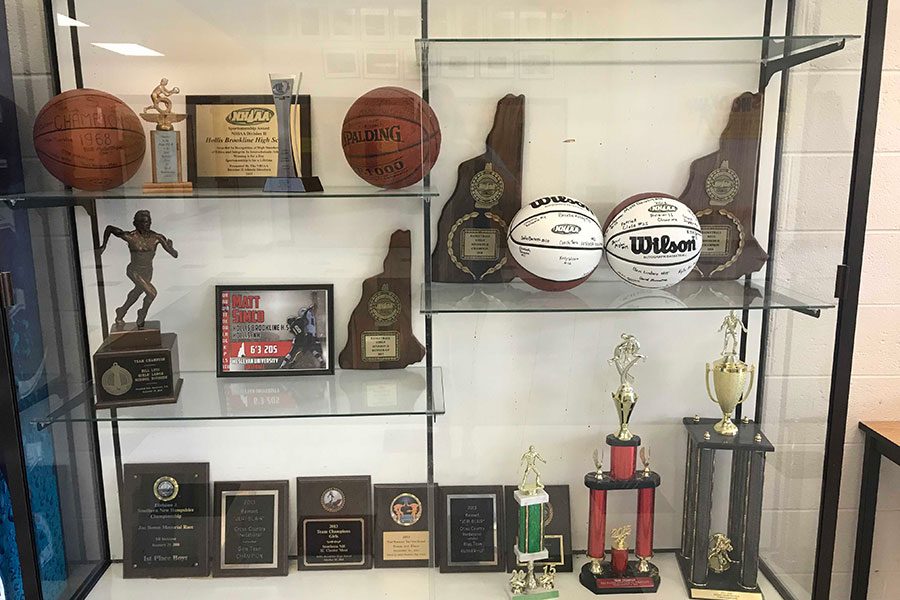 The D2 Hollis Brookline Girls Basketball team is looking to add to the collection of basketball fame for the school. This glass showcase is located in the back lobby in front of the gym holding the previous trophies and plaques for both girls and boys basketball. “Fortunately, we played our best team basketball in the playoffs,” said Murphy.
