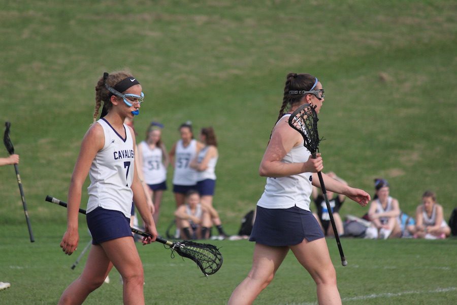  Making their way off of the field, Victoria Bruzik (left) and Tasha White (right) get a quick breather from the intense lacrosse game. 
