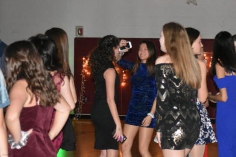Students dance at the Harvest Ball in the mini gym on Nov 2. “There was more effort into planning it, so its gonna be better,” Patel stated in the days leading up to the dance. Increased organisation and planning of the dance this year likely increased attendance at the event.