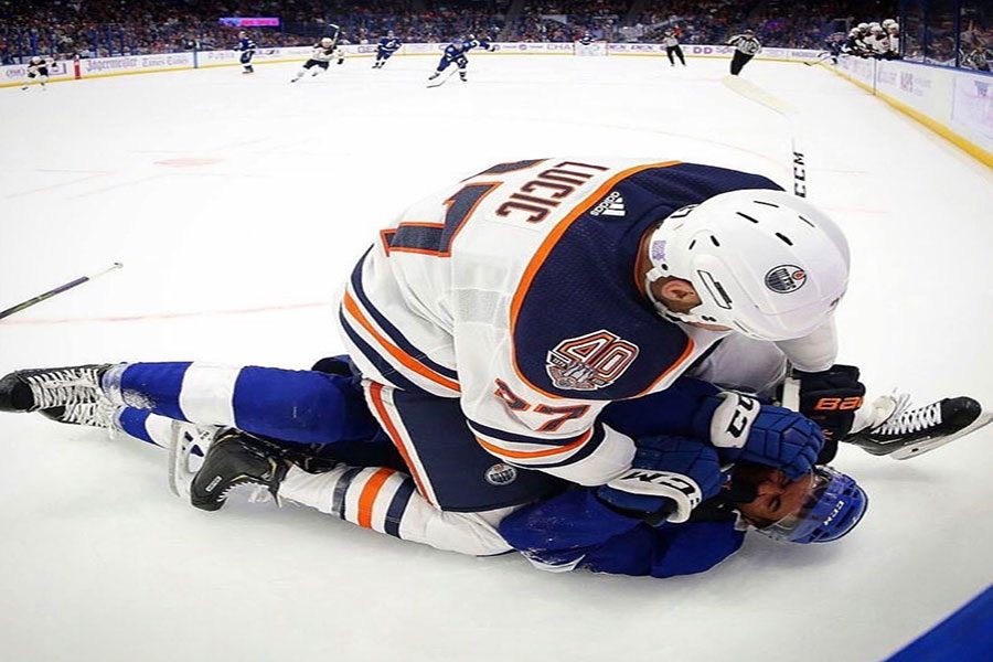  Milan Lucic #27 sits on, rookie, Mathieu Joseph after checking him. The hit cost Lucic a 10 minute penalty and $10k. “Part of the reason we have Looch [Lucic] here is to take care of teammates, and he did that,” said Todd McLellan who is head coach of the Edmonton Oilers. 
