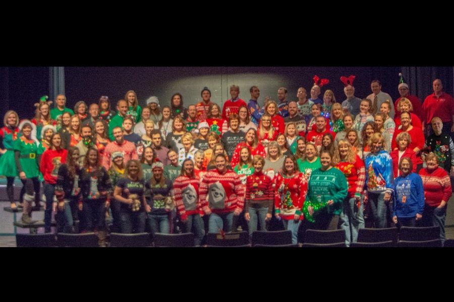 All+of+the+participating+staff+members+pose+for+a+group+photo+in+the+auditorium+yesterday+morning.+Sweater+day+was+definitely+a+big+hit+among+the+HB+staff+and+students%21+%E2%80%9CSweater+day+has+been+the+best+day+so+far+in+my+entire+experience+at+Hollis+Brookline+High+School%2C+because+I+get+to+wear+a+giant+unicorn+on+my+shirt+all+day+long%E2%80%9D+said+Heather+Hamilton%2C+English+teacher.+