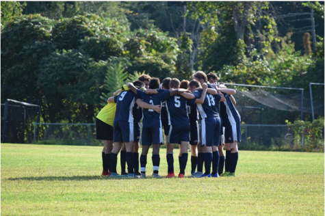 The boys huddle up together before their match. The team is currently 9-5-1 as they begin to wrap up their regular season. “I feel like we have grown both as players and brothers,” said Ethan Smith ‘21.