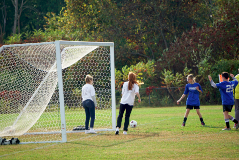 Members of the Unified Soccer Team go to defend the ball from the opposing team at Tuesday’s home game. The Unified Soccer Team was very successful in their first game, winning it 15-12 against Alvirne. “I love being able to kick the ball to my teammates,” said Beth Garcia ‘24.