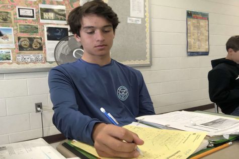 Public school returnee Aidan Dufoe ‘22 is working on a math assignment for class at Hollis Brookline High School. This is his first year back at public school after attending just one year at Bishop Guertin. “I prefer public school. It’s more of a community,” said Dufoe.