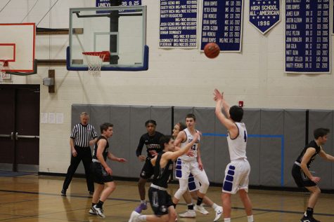 Matt Dias ‘21 at, attempting a 3-point shot against Hanover. Dias led the team in points to a victory, 70-63. “We knew going in that Hanover was probably the best shooting team we were going to play all season, so it was key that we closed out their shooters and sprinted back on defense,” said Dias.