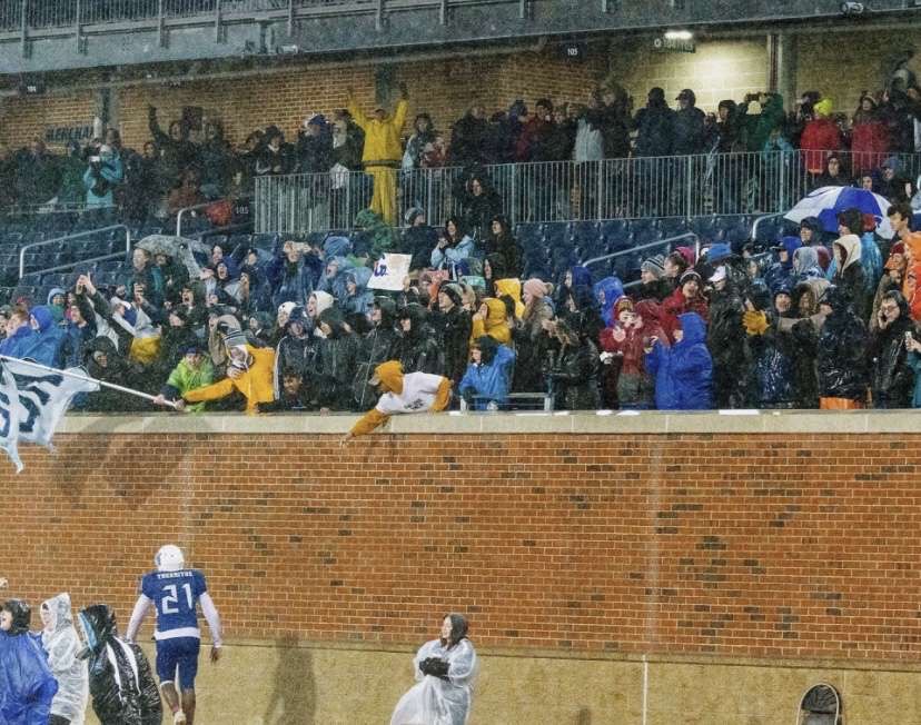 Marc-Andre Thermitus ‘21 goes to celebrate with the HB student section after winning the state championship game. “[The fans] were a huge part of playing that game, just the fact that so many people were willing to sit through that weather to support us really made a difference,” said Blake Bergerson ‘21