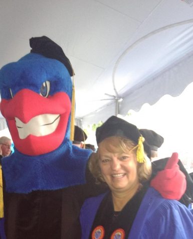 Salamone poses for a picture with the mascot at her college after her doctoral Graduation. 