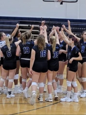 The HB Varsity Volleyball team celebrates a win against Manchester Memorial during a tribute game to Jeanie Dreyer. We are a very competive team and we work together during every match to beat our competitors, said Meaghan Coutu, 22. 