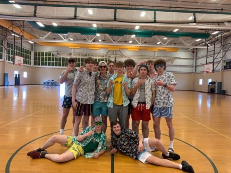The boys Varsity Volleyball team posing for a picture in their pregame Uniforms, they had some fun and decided to do a Hawaiian theme. 