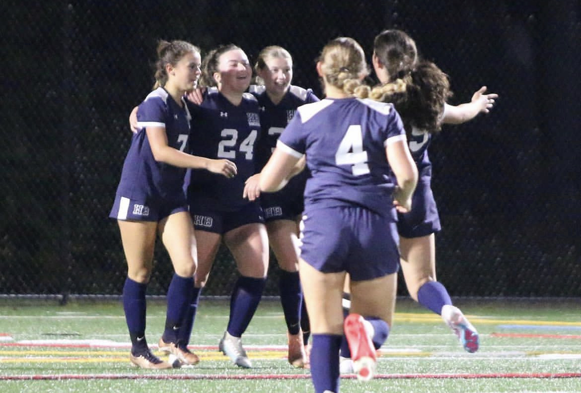 The Girls Soccer team celebrates after Sienna Anderson ‘24 scored the first goal of the game. The goal was the first of many to lead them to a successful 10-0 win against Pelham. “We are 10-0 right now; we’ve come so far,” said junior forward Lilly Bouchard ‘25. 