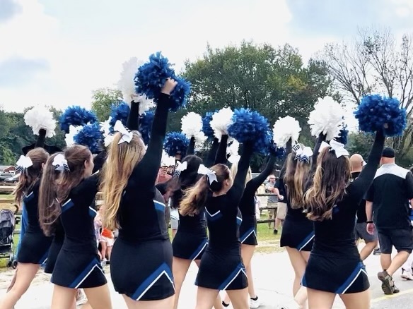 The HB Cheer Team participates in the 2023 Hollis Old Homes Day parade. They are in the middle of their fall season and have been doing better than ever. “This season already feels really special,” said coach Christina Ellis. 