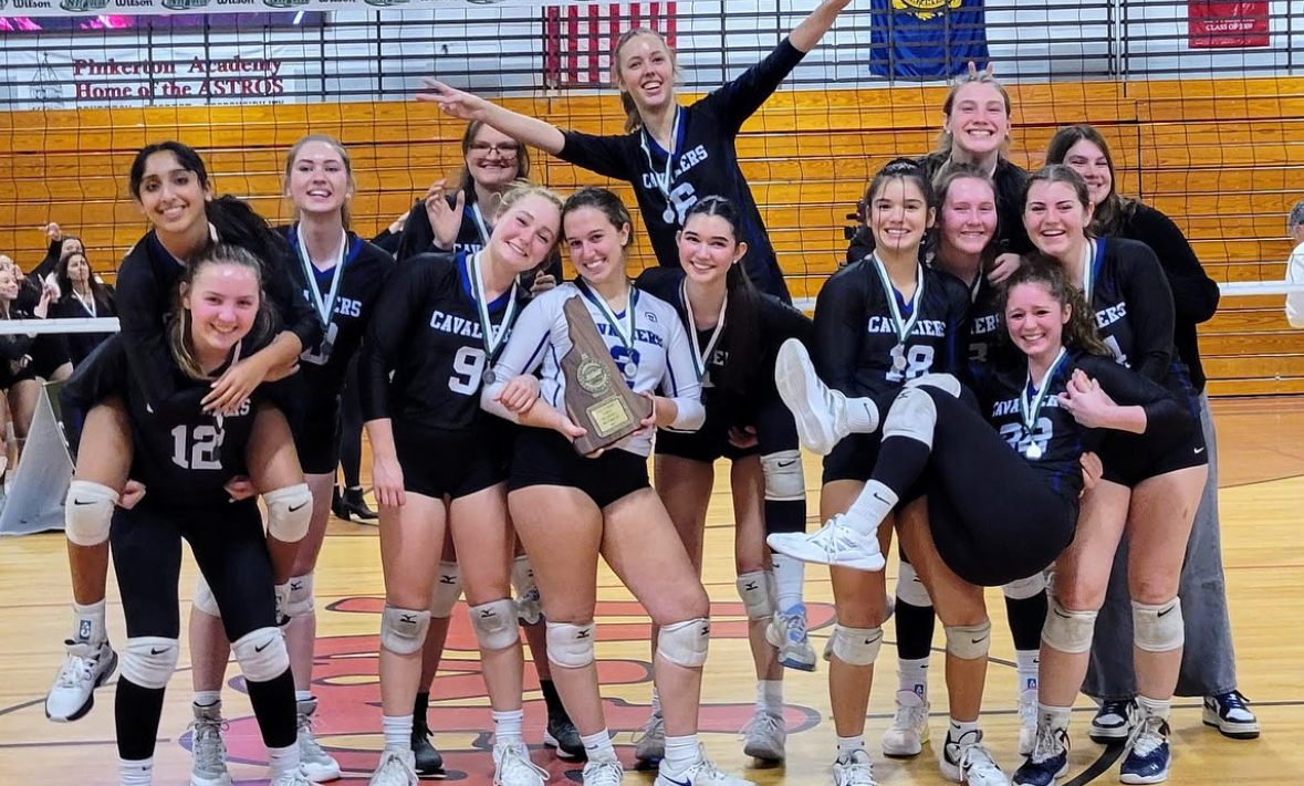 The+HB+Varsity+Girls+Volleyball+team+celebrates+their+runner-up+title+at+the+Division+1+championship+game.+The+girls+ended+their+season+with+an+18-3+record+after+the+title+match+against+Bedford.+%E2%80%9CThis+year%2C+I+think+the+team+spirit+is+really+good.+We+all+enjoy+ourselves+on+the+court%2C+and+that%E2%80%99s+all+that+matters%2C%E2%80%9D+said+Lolly+Adair+%E2%80%9825.+%28Photo+courtesy+of+the+HB+Athletic+Booster+Club%29