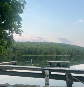 A peaceful sun sets over YMCA Camp Coniston, where the author attends.