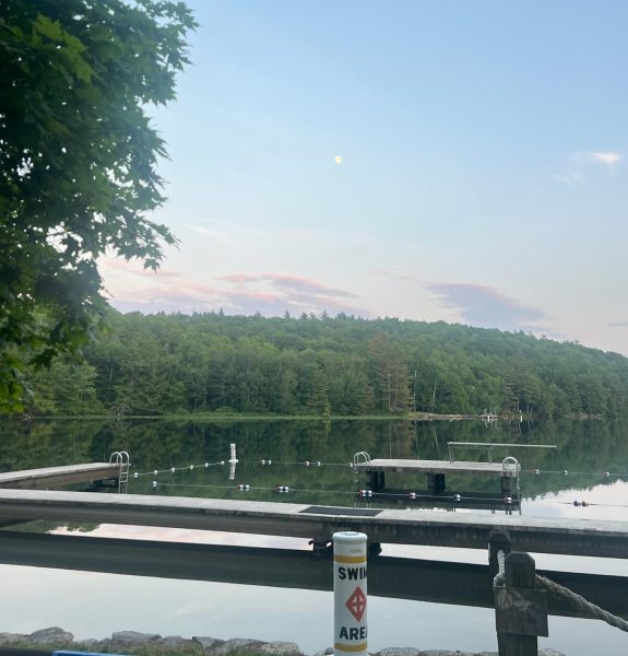 A peaceful sun sets over YMCA Camp Coniston, where the author attends.