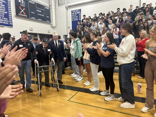 Local veterans are greeted by the senior class as they walk into the gymnasium for the assembly. Local veterans attend the assembly every year to be recognized for their service. “It's always nice when someone thanks you for doing really important things,” said Homefront Club advisor and Civics teacher Trevor Duval.