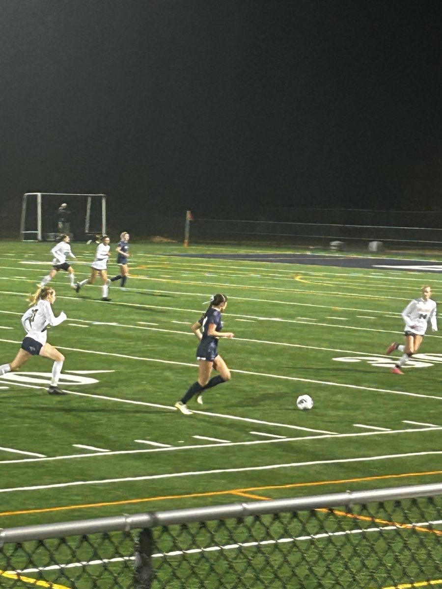 Defensive player Kiera King ‘25 moves the ball back up the field to keep Hollis Brookline in possession of the ball during their 2024 New Hampshire Division II State Championship game against Bow. The Cavaliers ended up winning 1-0 with Marleigh Kreick ‘26 scoring the game-winning point. “They’ll still do pretty good next year because they still have a lot of great players and great talent,” said King. (Photo courtesy of Brynn Spencer)