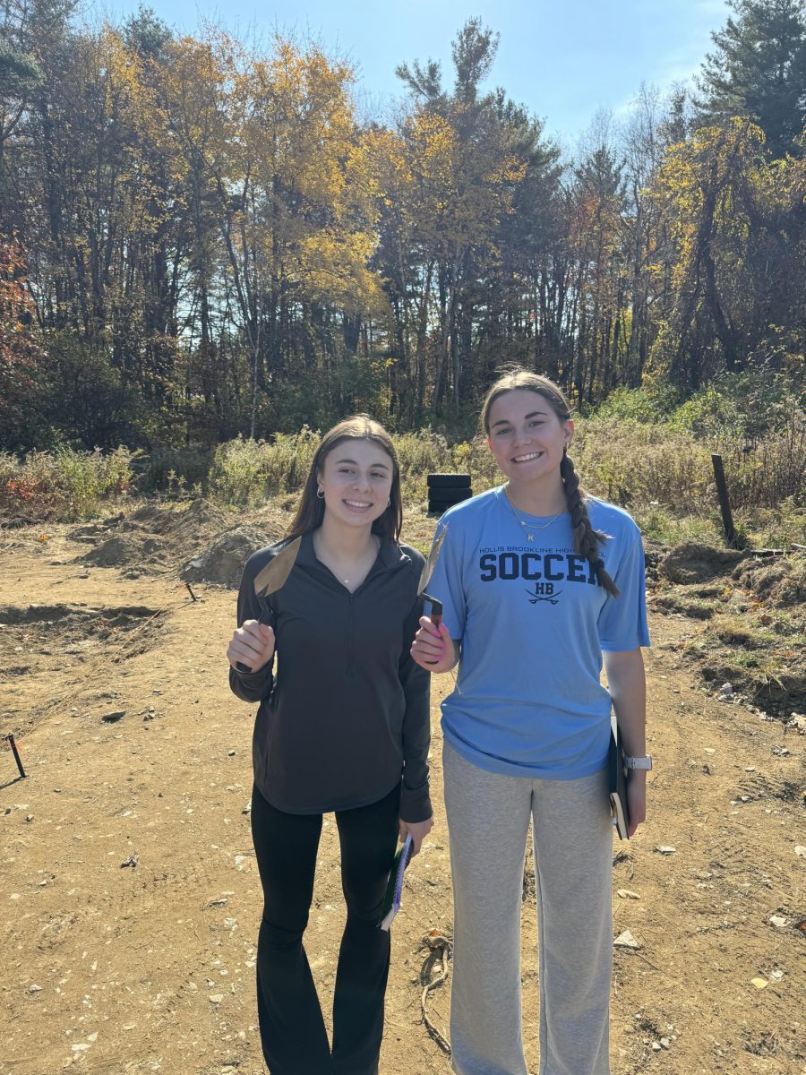 Students Audrie Green ‘25 (left) and Kiera King ‘25 (right) pose with their archeological tools.