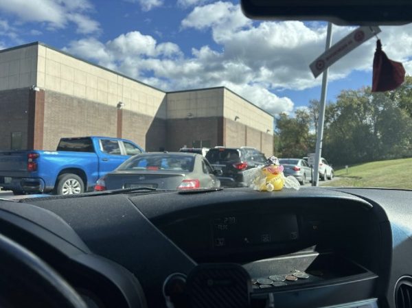 Students wait in line, eager to get home and leave school grounds.