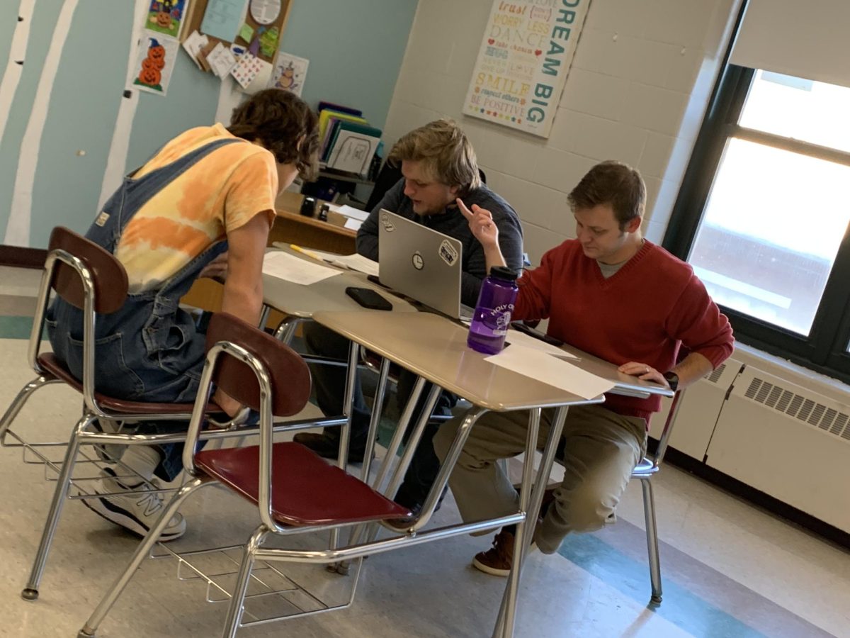 An HBHS student (left) and staff Matthew Portu and Dylan Silcox (right) work hard to come up with new ways to improve the new Faculty-Student Choir.