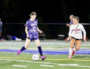 Molly Reardon '26 runs while playing for the Hollis Brookline Varsity Girls Soccer team. (Image courtesy of Reardon)