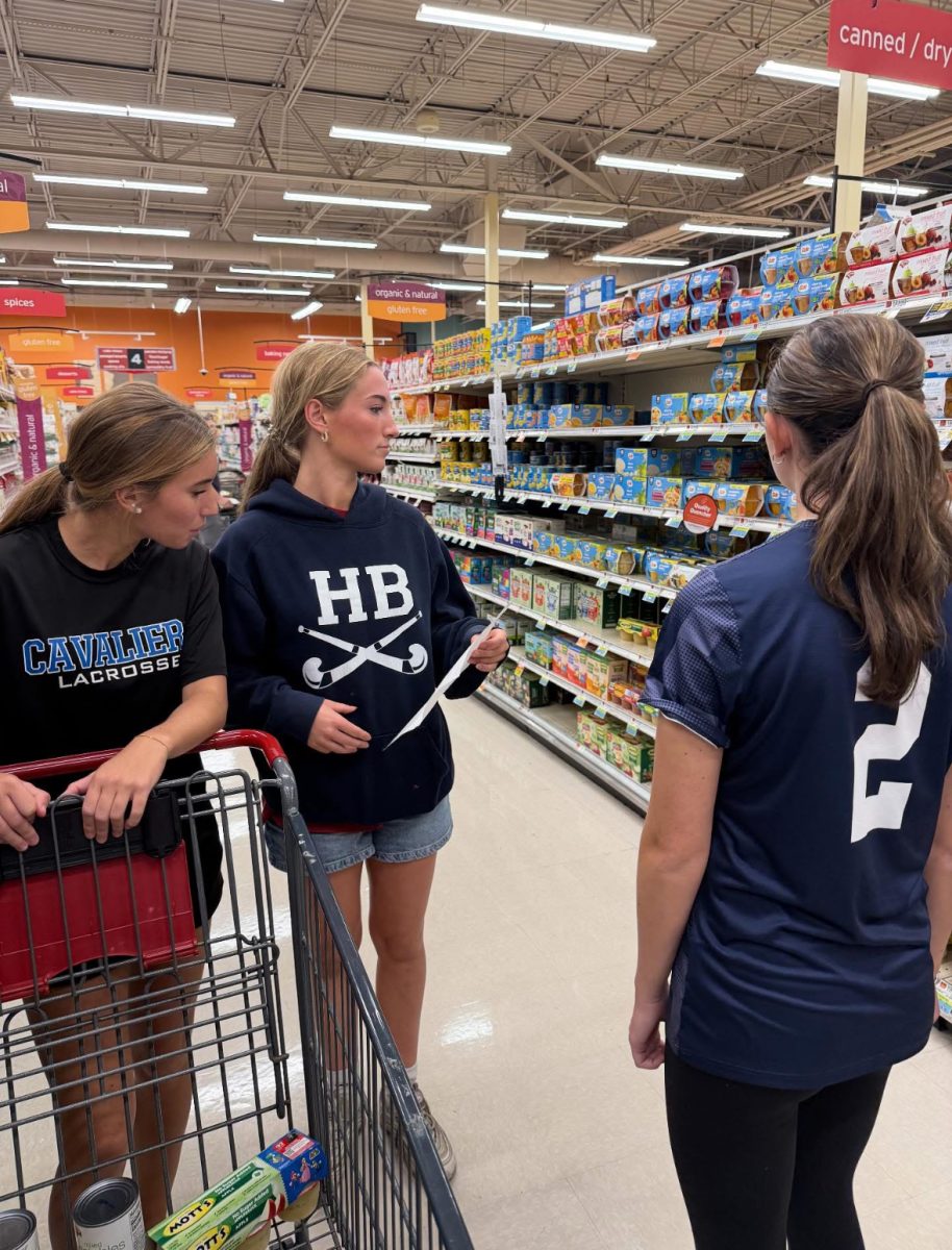 Elise Broadhurst, Brooke Bouchard, Sam Disco collecting canned goods